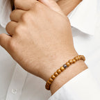 Kralenarmband lichtbruin hout 6,5 mm 19 - 26 cm zilver gerhodineerd met rubber/nylon/leer