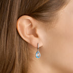 Klapoorringen blauw topaas 14k witgoud