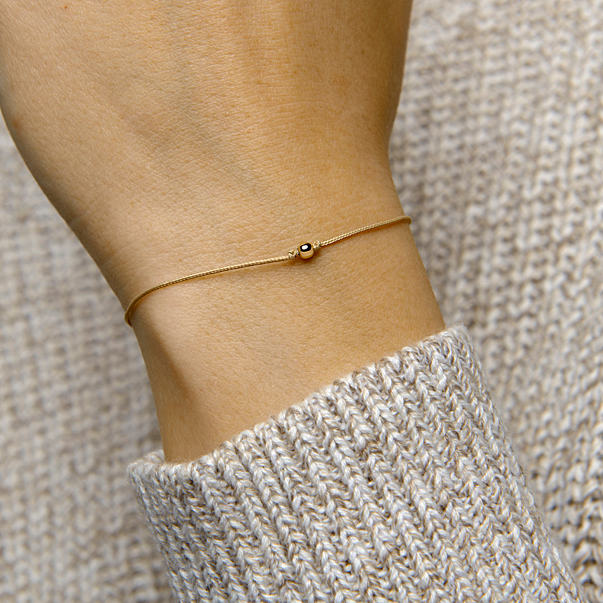 Armband katoen bolletje 13 - 19 cm 14k goud met rubber/nylon/leer