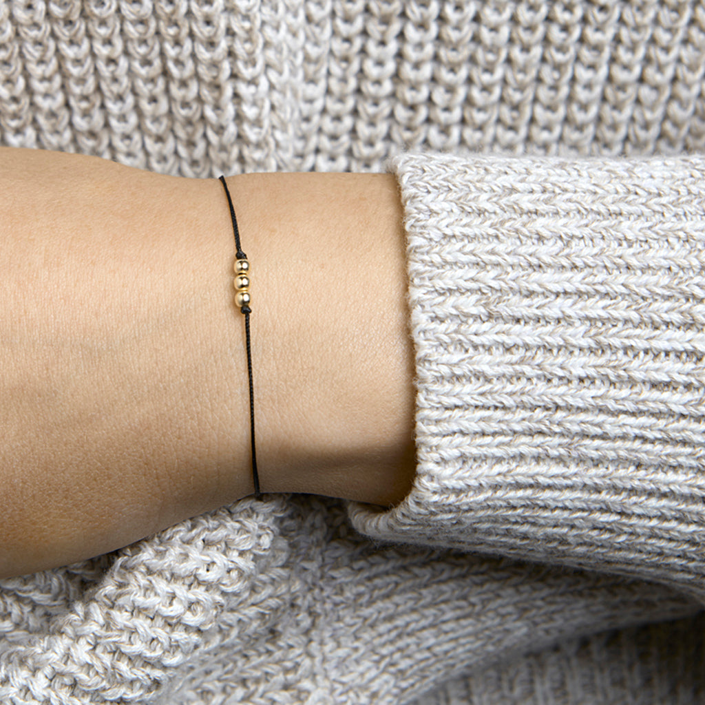 Armband katoen bolletjes 13 - 19 cm 14k goud met rubber/nylon/leer